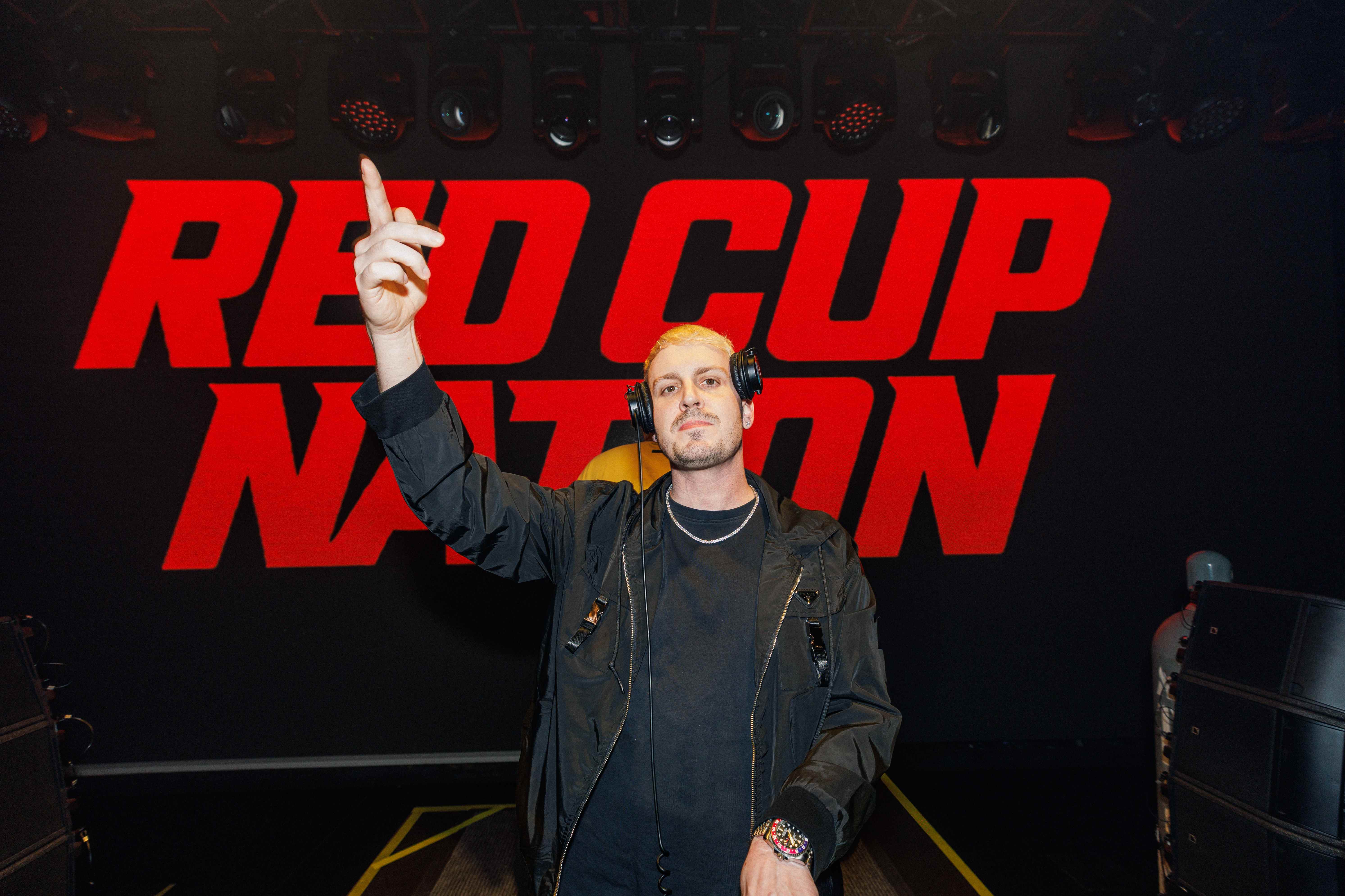 DJ in front of large Red Cup Nation logo backdrop
