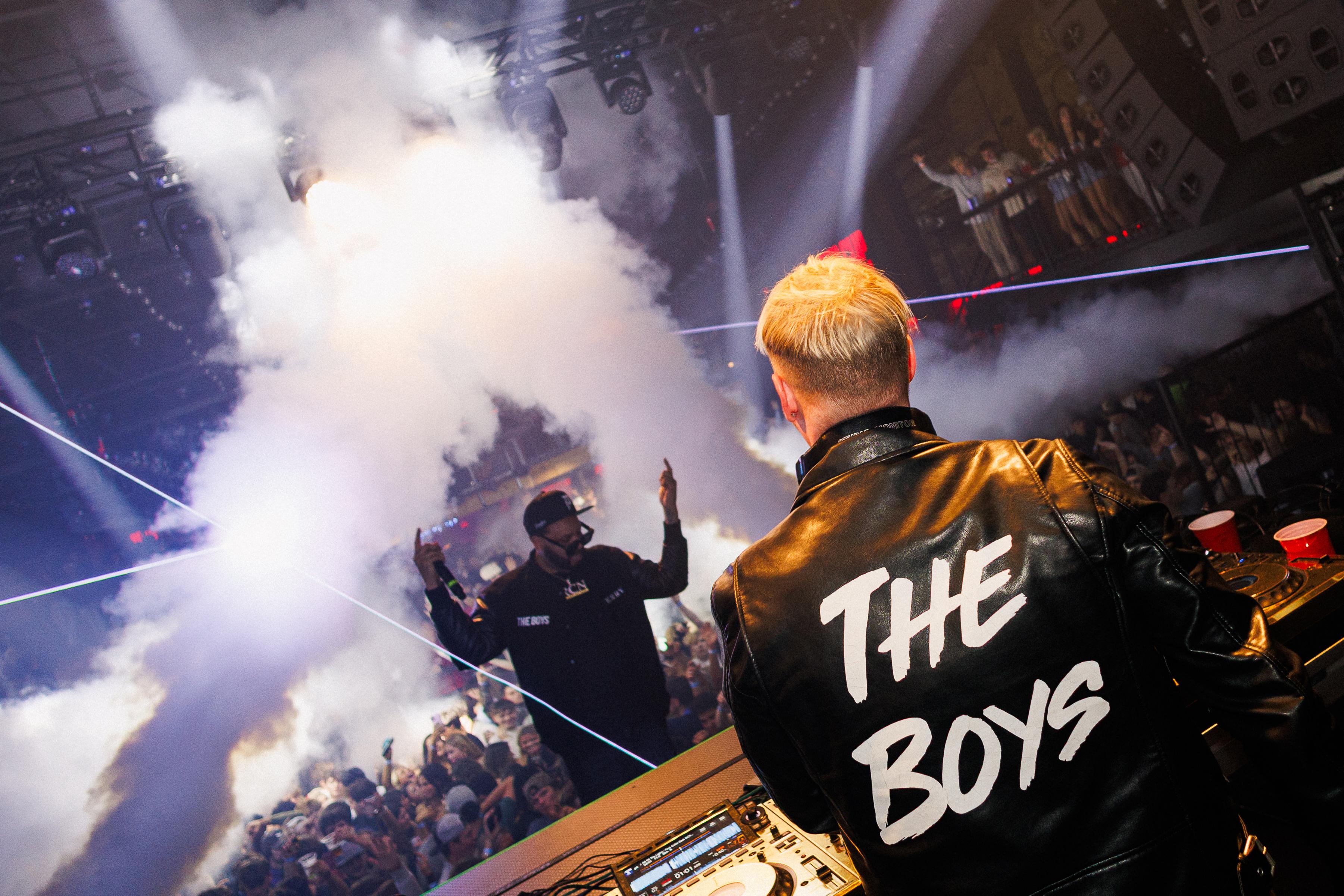Stage performance with pyrotechnics and The Boys jacket